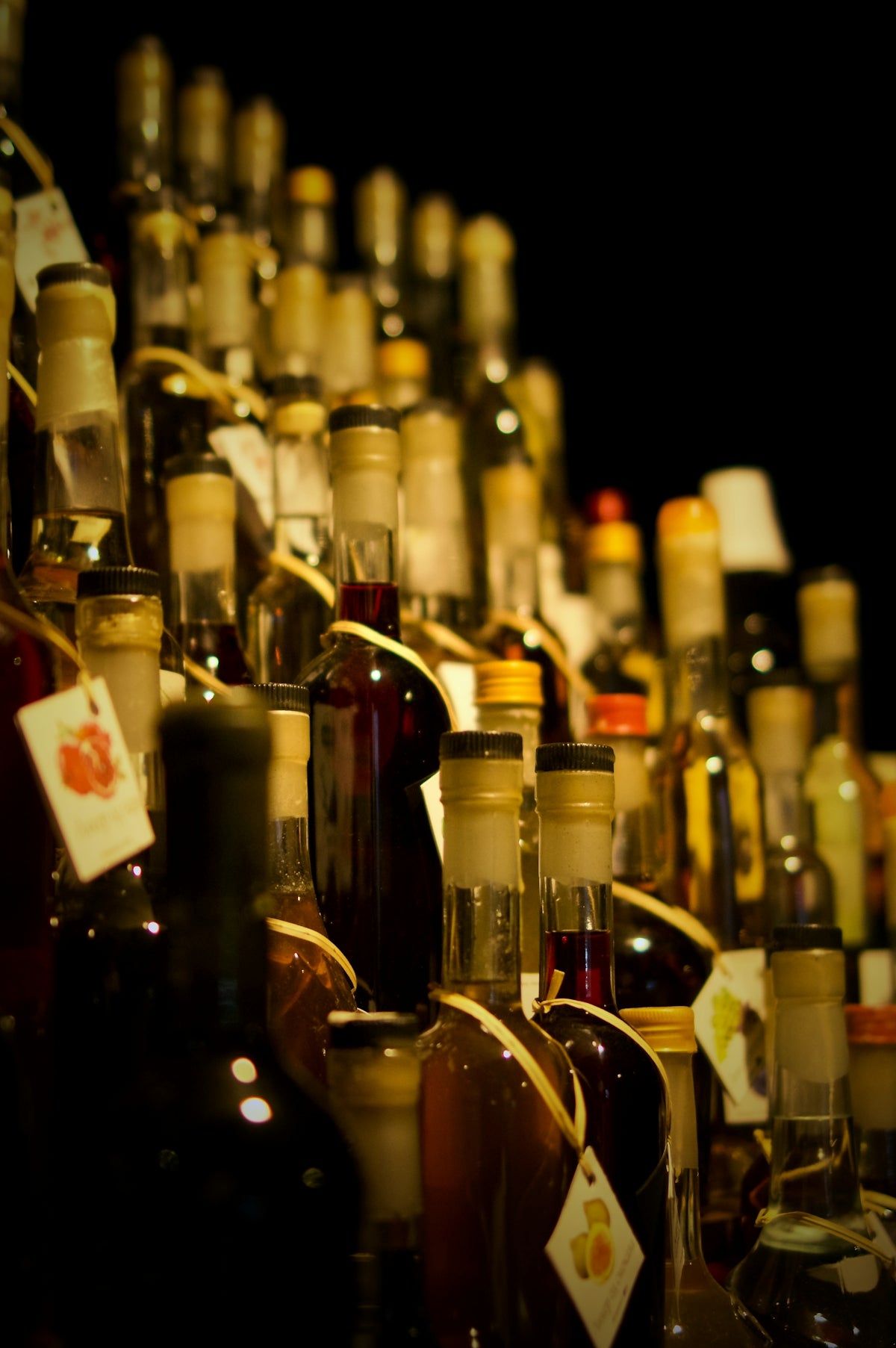 A large amount of bottles of alcohol are stacked on a shelf